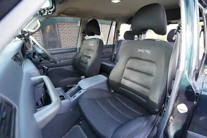 Gray interior of a vehicle with visible branding on the seat