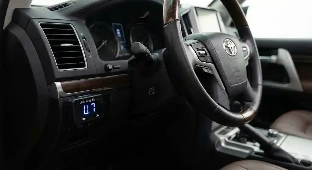 Interior view of Toyota LandCruiser 200 Series Sahara dashboard showing Ultimate9 EVC Throttle Controller mounted near the start button.