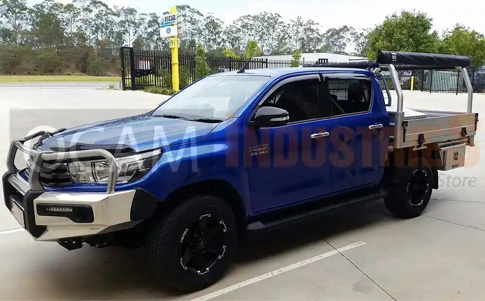 Blue Toyota truck with an open bed in a parking lot.