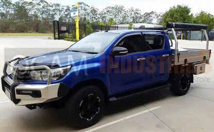 Blue Toyota truck with an open bed in a parking lot.