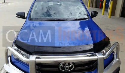 Blue Toyota vehicle with a front bumper guard on a concrete surface.