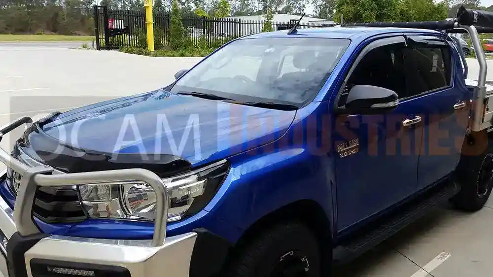 Blue pickup truck with a bull bar on a road