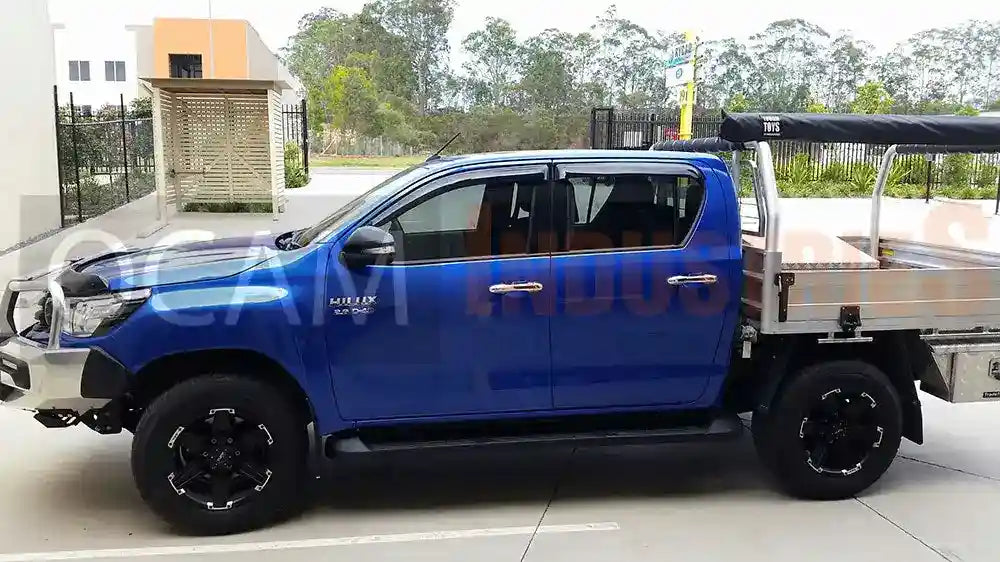 Blue truck with a flatbed on a paved surface