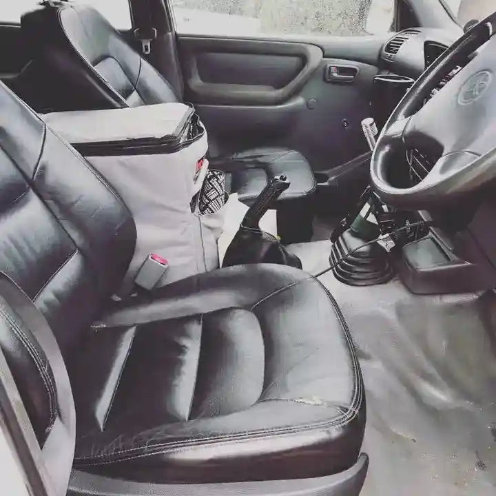 Car interior with black leather seats and steering wheel.