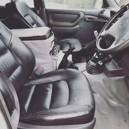 Car interior with black leather seats and steering wheel.