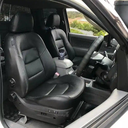 Car interior with black leather seats and steering wheel.