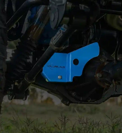 Blue Diff Lock Protector on a LandCruiser 70 Series vehicle with grass in the background