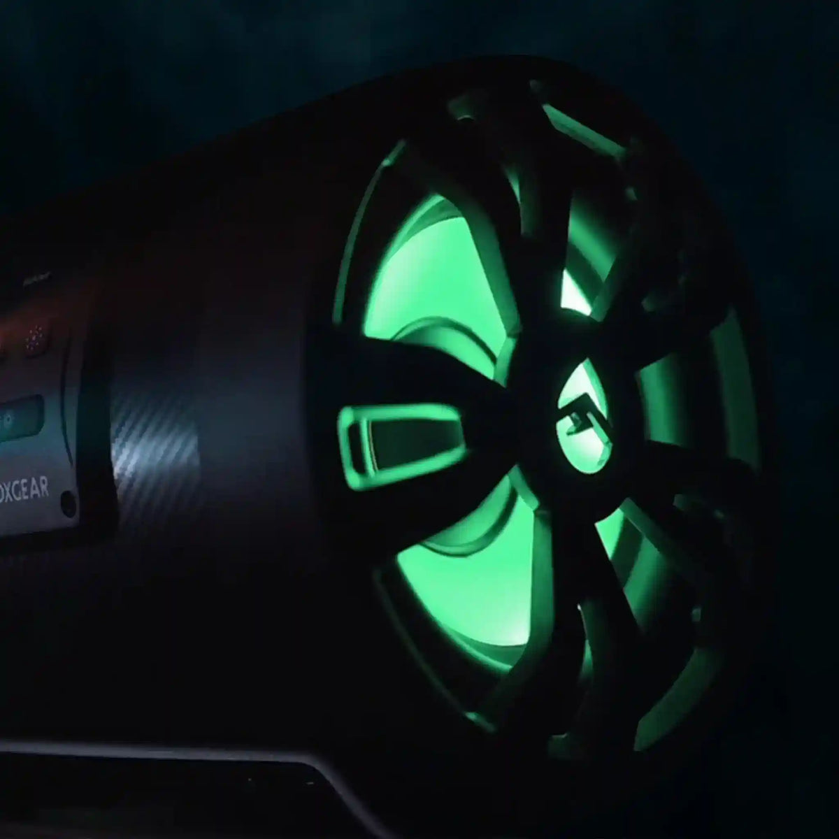 SoundExtreme ES08 SUBWOOFER with green glowing interior and flashlight on a dark background