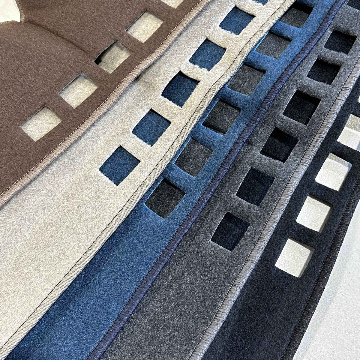 dash mats in brown, gray, blue, and black.