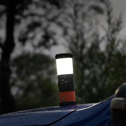 Portable lantern on a vehicle roof with trees in the background