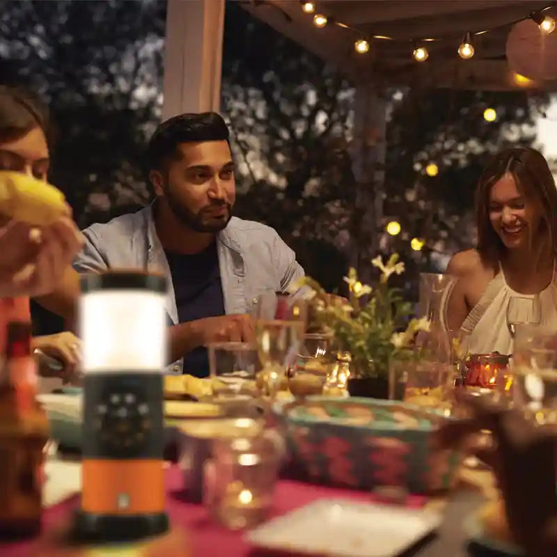 People enjoying a meal together at an outdoor dinner party