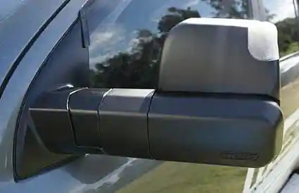 Side view mirror of a vehicle with a visible brand logo.