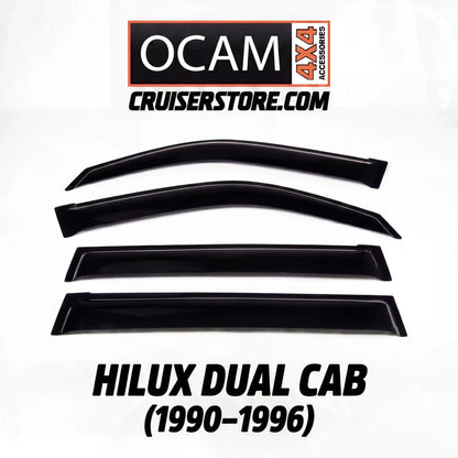 Set of black window deflectors for Hilux Dual Cab with OCAM 4x4 Accessories branding on a white background.