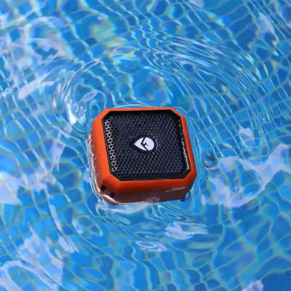 Orange and black waterproof speaker floating on water