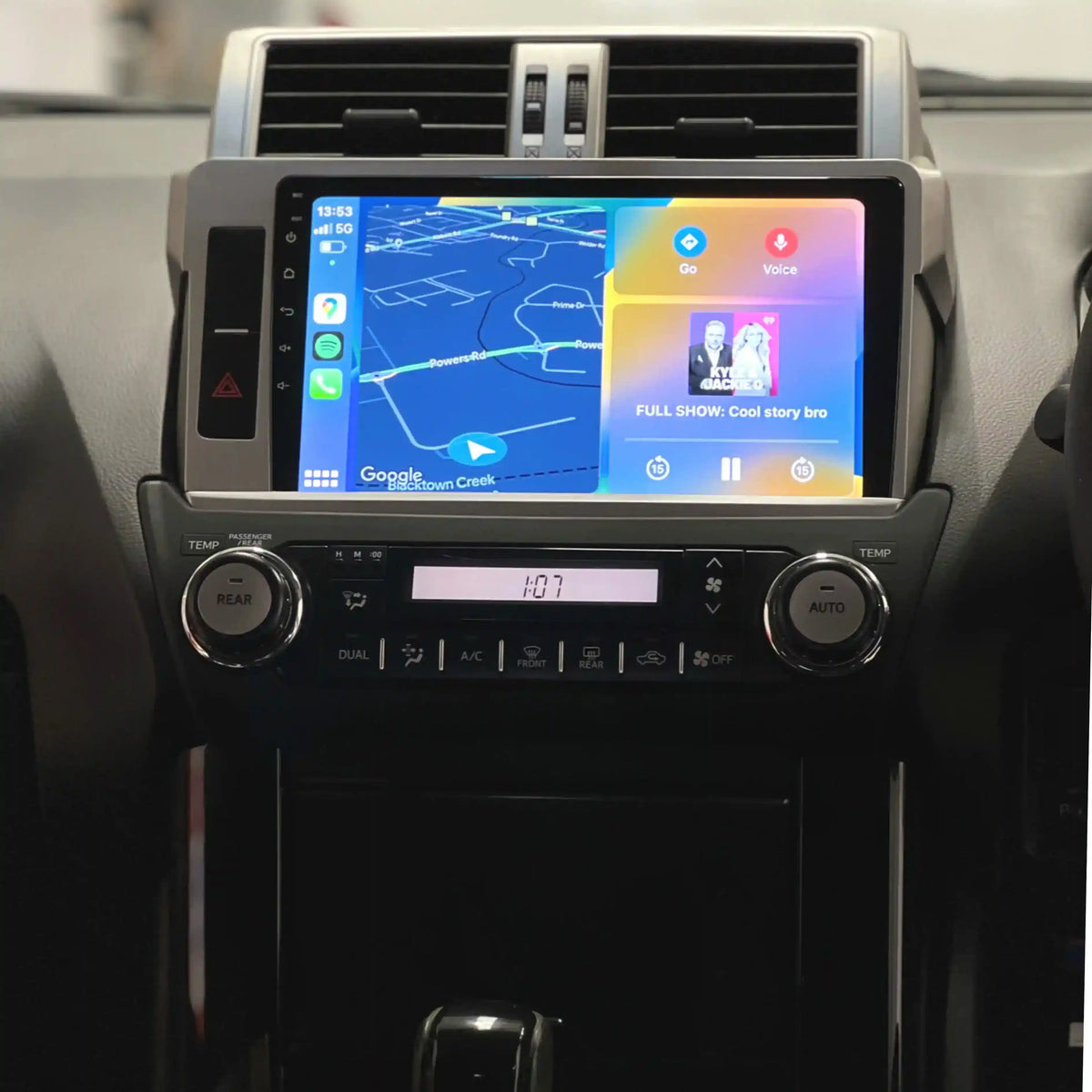 Car dashboard with a touchscreen display showing navigation and entertainment apps.