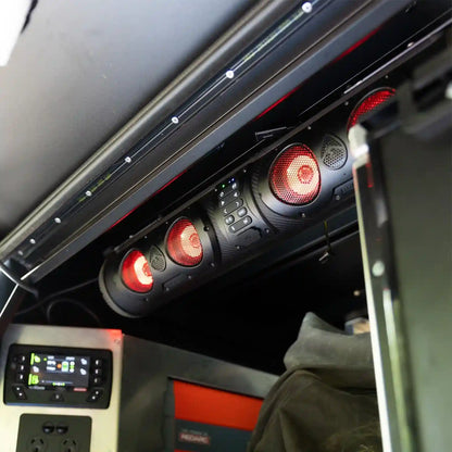 Close-up of a SoundExtreme SE26 with red lights and control panels.