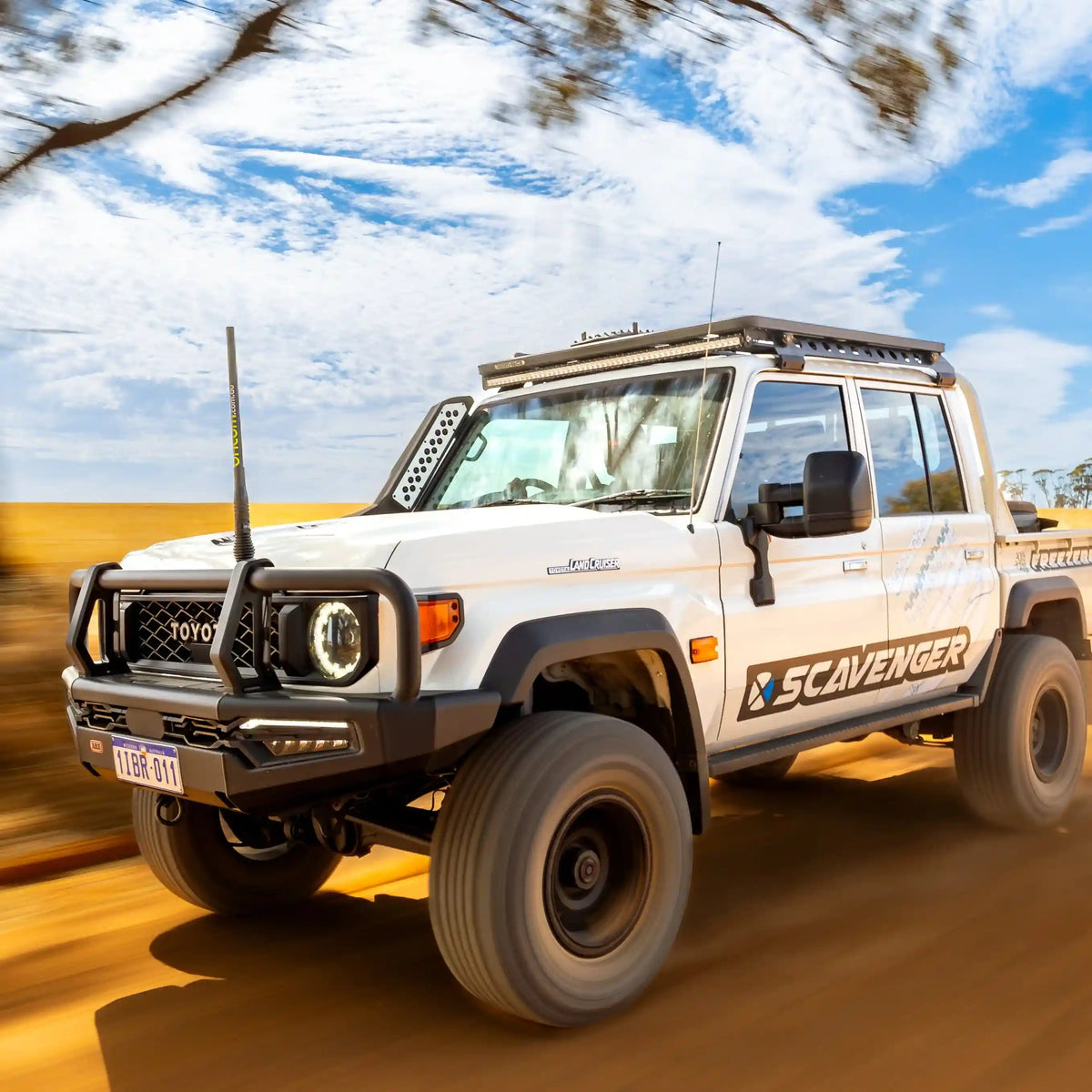 White Toyota SUV with 'Scavenger' branding on a road with blurred background