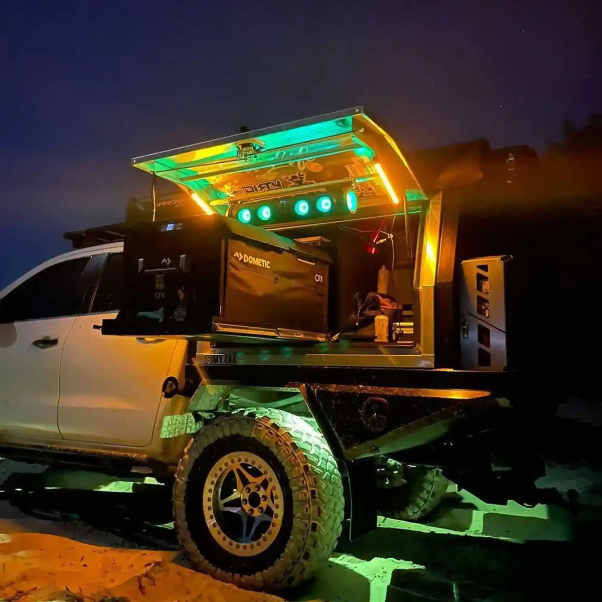 Customized off-road vehicle with open cargo area at night