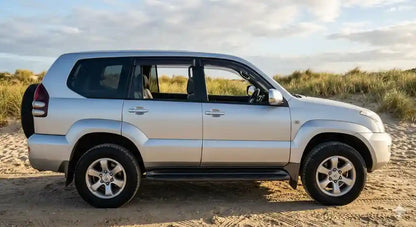 Side profile of Silver Toyota Prado 120 Series GXL with OCAM weather shields installed on all doors.