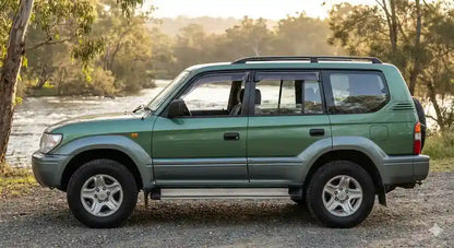 Side view of Green Toyota Prado 95 Series GXL with OCAM weather shields installed on all four doors.