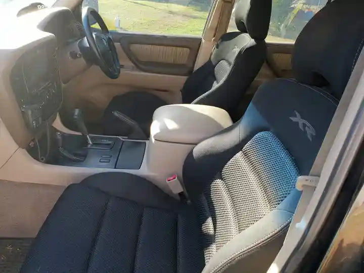 Car interior with black and gray seats, steering wheel, and dashboard.